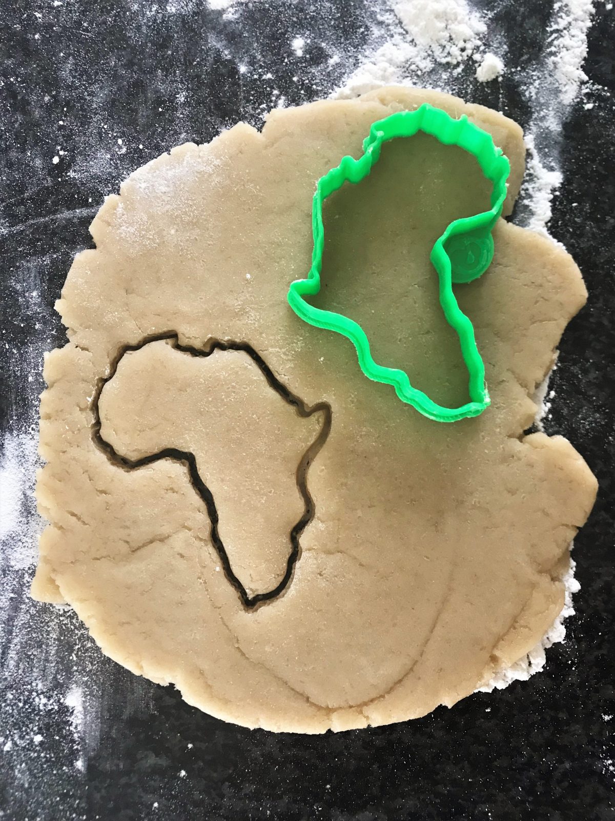 Africa outline cookie cutter on dough