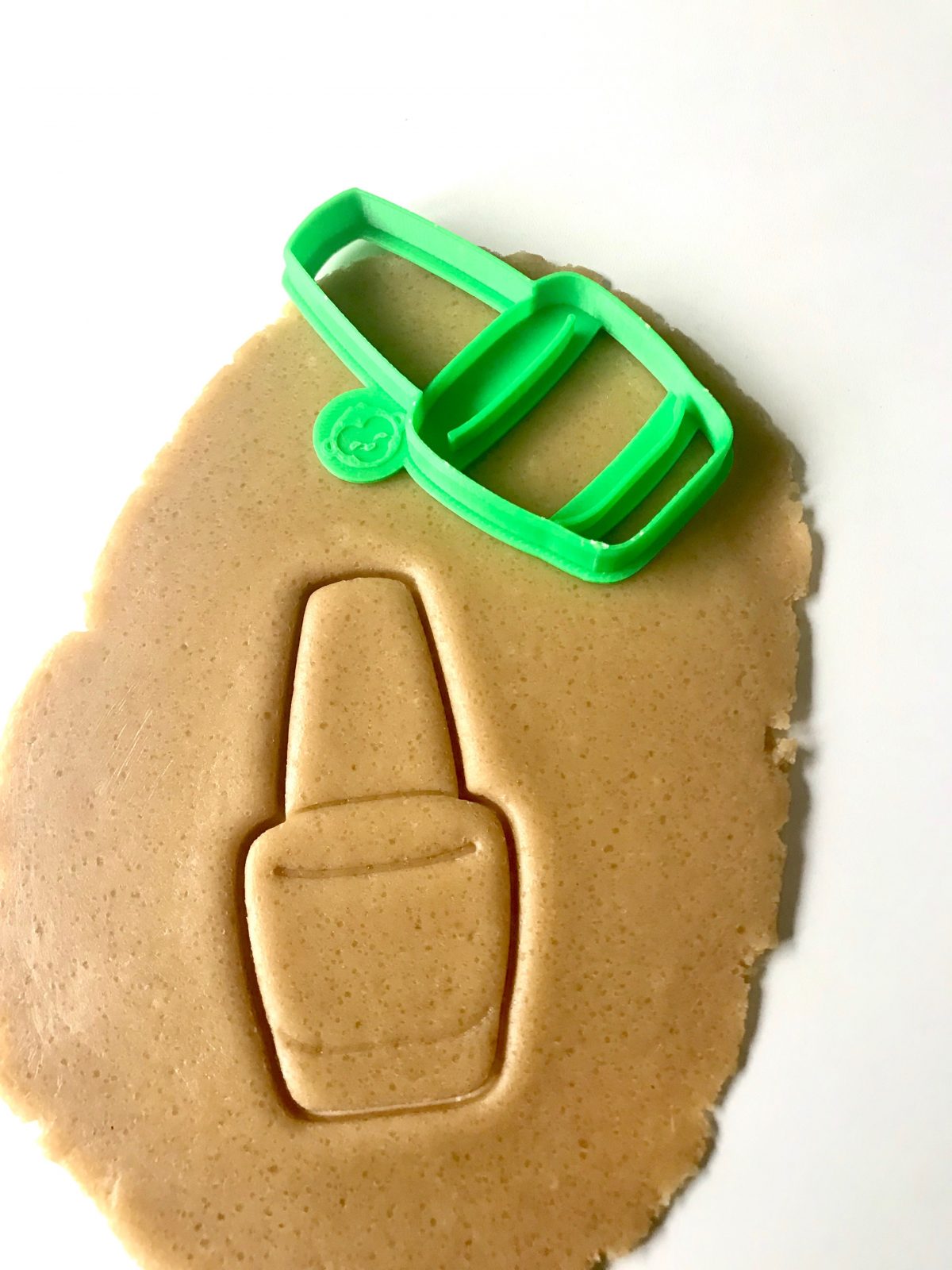 nail polish cookie cutter on dough